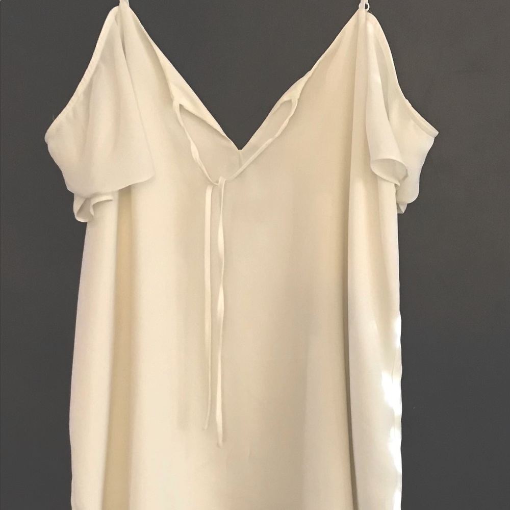 Lined 100 % polyester cold-shoulder blouse w adjustable straps.